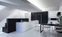 A geometric kitchen in dark oak and high-gloss white lacquer.